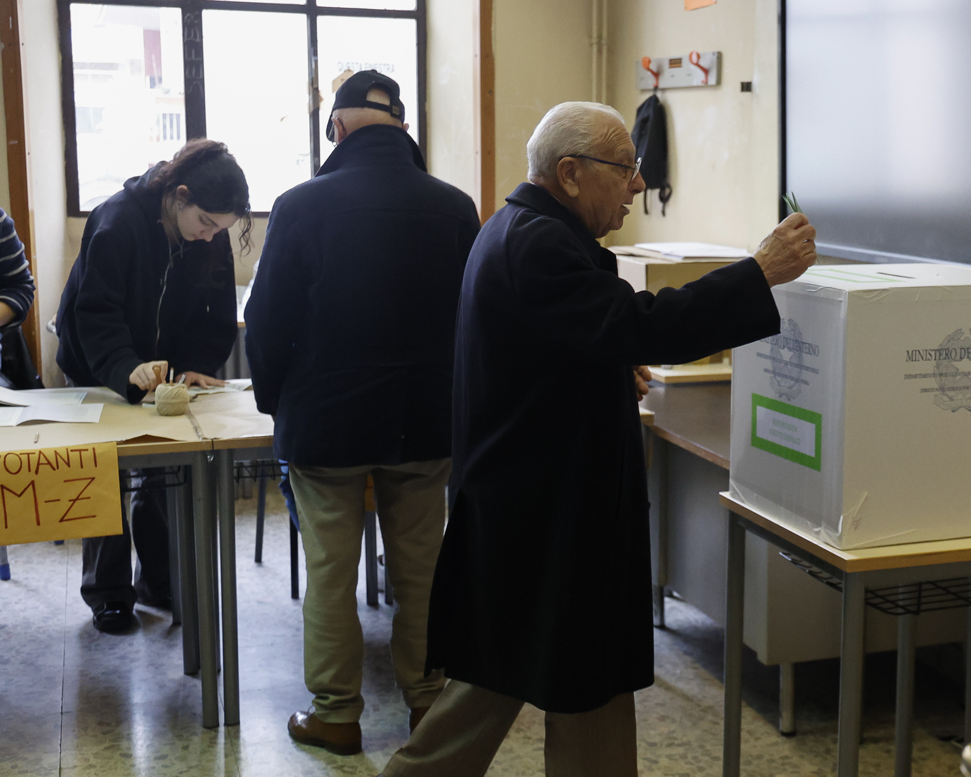 Un votante depositando su voto en Roma.